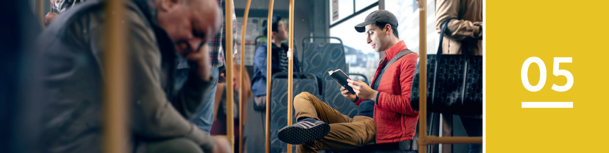 Lesson 5. A man reads the Bible while he rides on a bus.