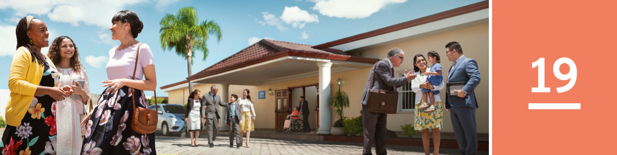 Image 1: Jehovah’s Witnesses talk to one another outside of a Kingdom Hall.