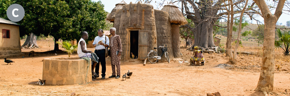 Image 4: C. Two of Jehovah’s Witnesses preaching to a man in a rural village in Benin. C. Benin,