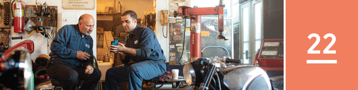 Image 1: A Bible student preaches to his workmate during a lunch break in a repair shop.