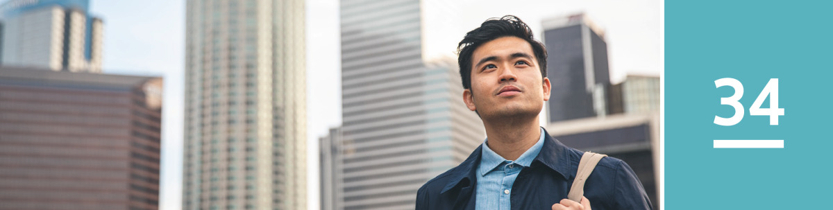 Image 1: A man in a city looks contemplatively toward the heavens.