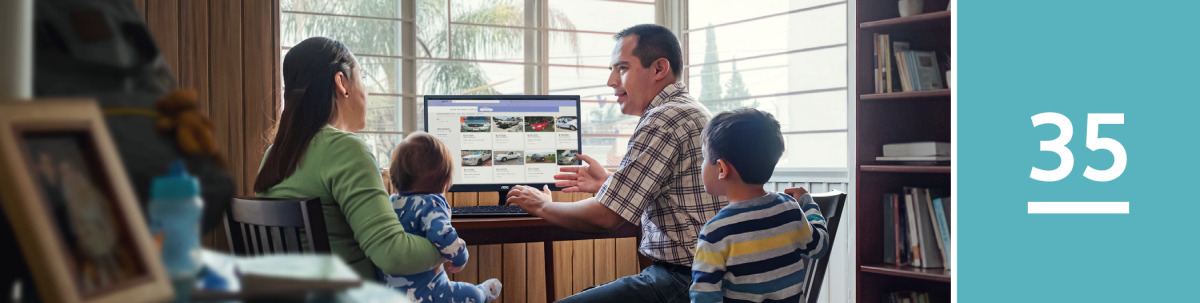 Image 1: A husband researches cars advertised on a website as his wife and children look on.