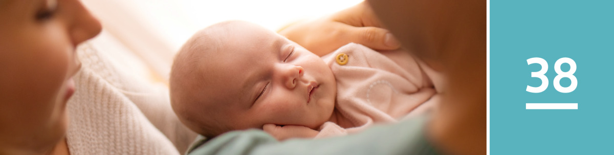 Image 1: A husband and wife cuddle their baby.