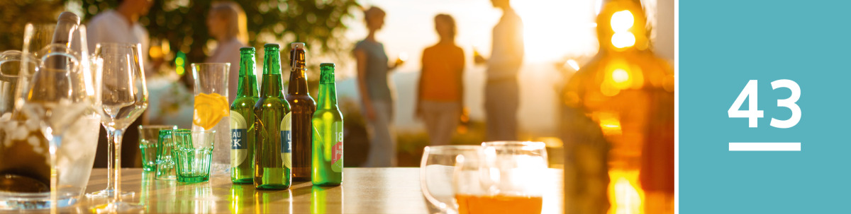 Image 1: Alcoholic and nonalcoholic beverages sit on a counter at a gathering.