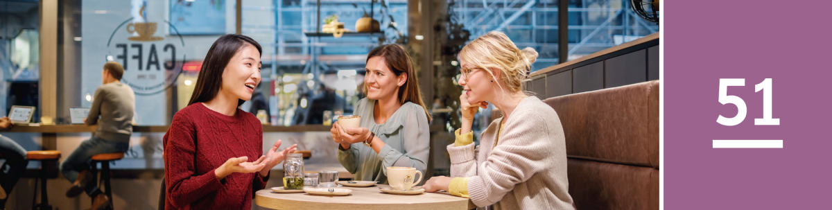 Image 1: Three women converse happily in a coffee shop.