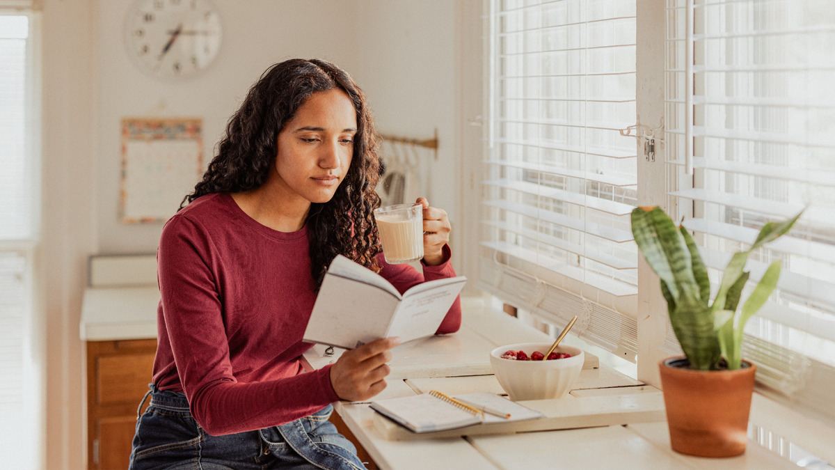 Uma irmã lendo o texto diário durante o café da manhã