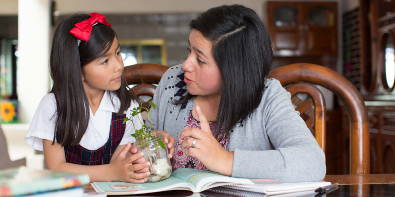 IMAGE 2 PICTURE DESCRIPTION: A mother teaches her daughter about Jehovah as they look at a plant together CAPTION: Teach your children Bible truth whenever possible (See paragraph 10)