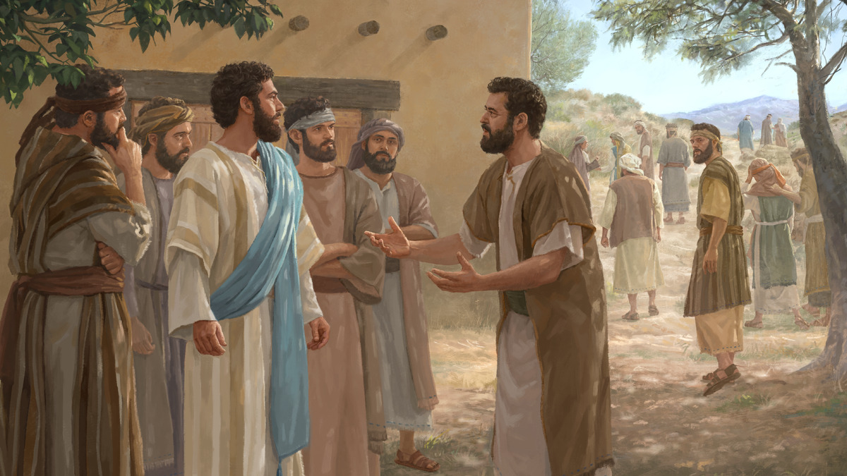 Perto de uma casa de barro, Pedro fala com Jesus gesticulando com as duas mãos abertas, cercado pelos outros apóstolos, enquanto ao fundo várias pessoas se afastam pela encosta seca
