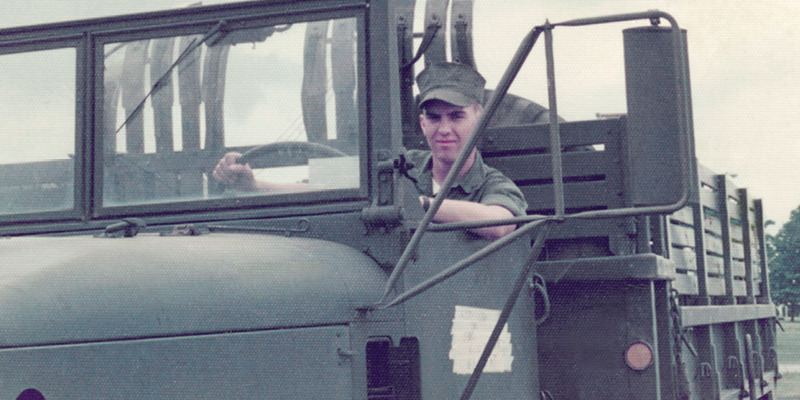 IMAGE 3 PICTURE DESCRIPTION: Michael Kuenzle as a member of the U.S. Marine Corps, driving a truck.
